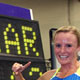  Shalane Flanagan poses next to the clock displaying her new American Record in the 5000m.